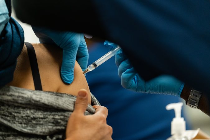 A woman receives the Moderna COVID-19 vaccine in Maryland in 2022. (Eric Lee/For The Washington Post)