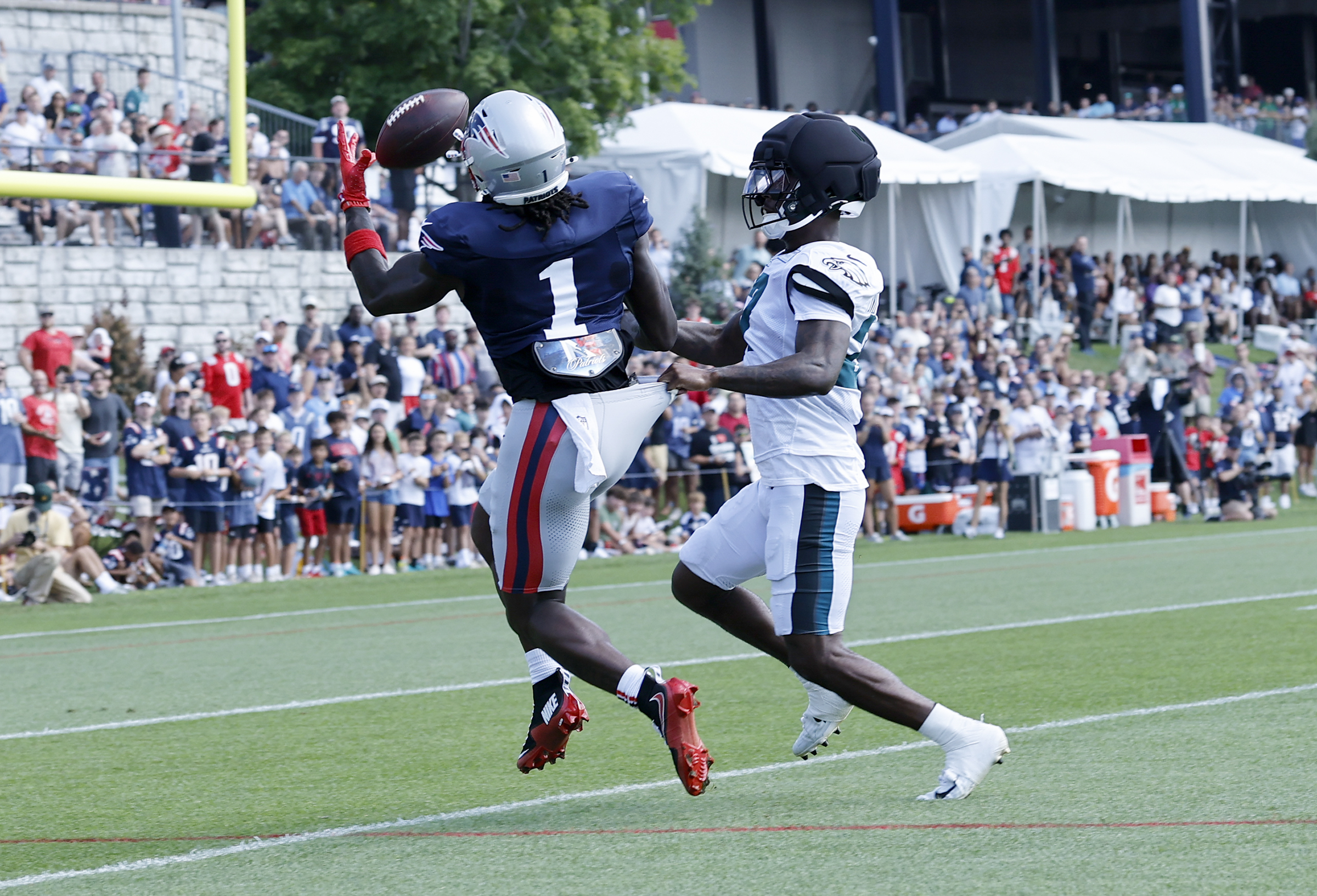New England Patriots wide receiver A.J. Brown attempts to catch the football defended by Eagles cornerback Quinyon Mitchell on Wednesday.