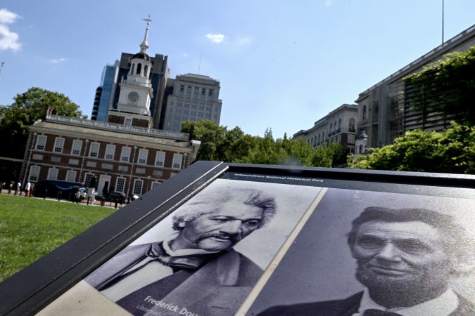 A panel titled “Intoning Inspiration” in front of Independence Hall in Independence National Historical Park Monday, July 28, 2025, shows three Americans who spoke at the Hall and Liberty Bell. Abolitionist Frederick Douglass (left) gave a speech against slaveholding in 1844; President-elect Abraham Lincoln (right) stopped on his inaugural journey to Washington D.C. in 1861 and pondered the meaning of “all men are created equal; ” and Suffragette Susan B. Anthony (not shown) and others disrupted the nation's centennial celebration on July 4, 1876 to read the “Declaration of the Rights of Women of the United States.”
