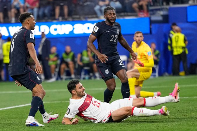 Auston Trusty (left) and Mark McKenzie (center) watching Turkey's Kaan Ayhan score the last-second game-winning goal.