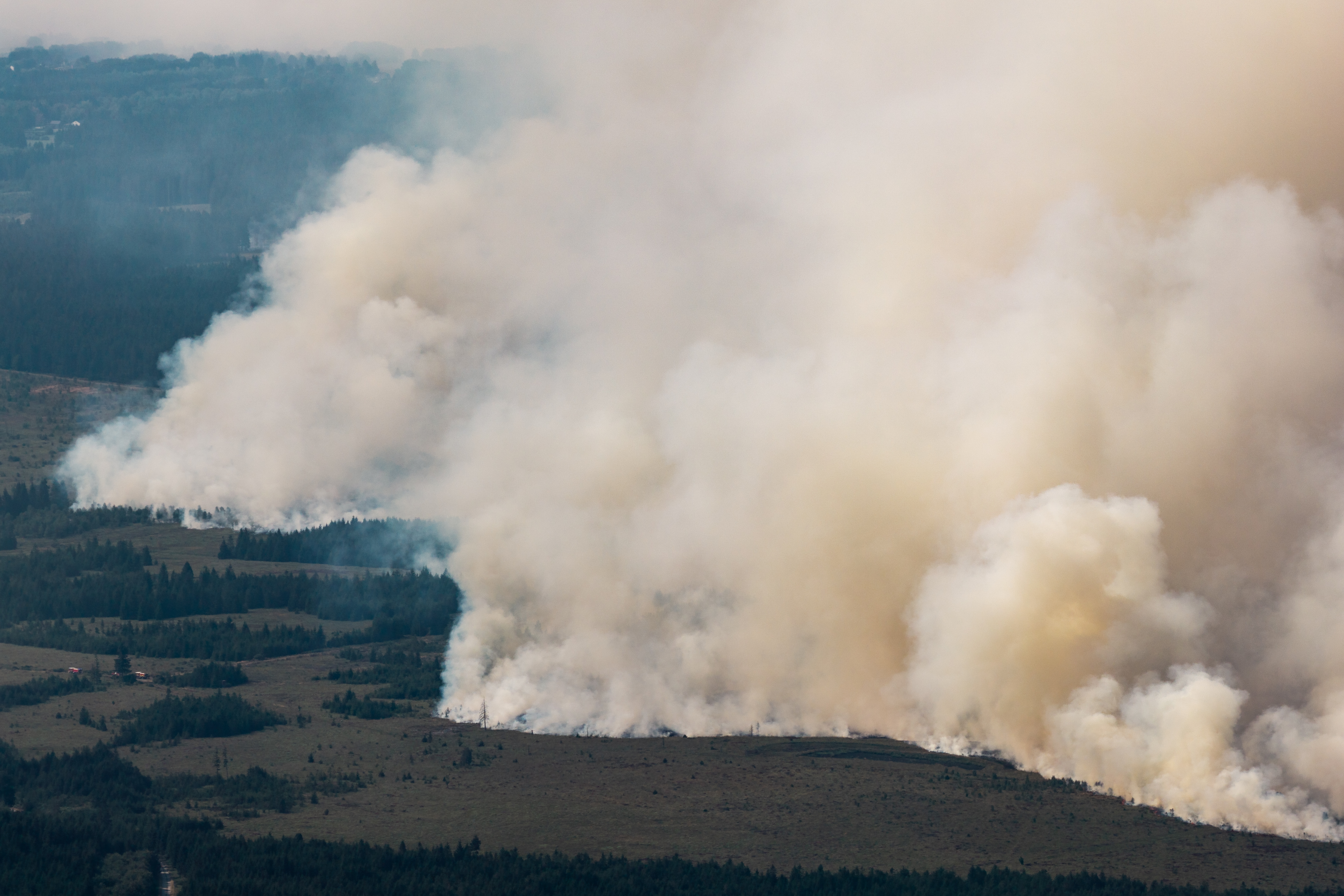 Firefighters battle massive blazes in Belgium and Greece as 2 die on an island near Athens
