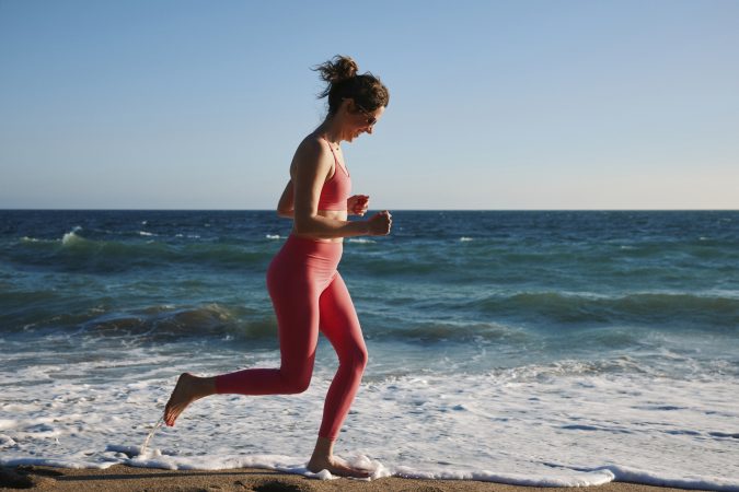 Natalie Burtney works out at Point Dume State Beach in Malibu, Calif. The beach can be a playground for adults and allow you to move in new and different ways, which can bring fitness benefits you can’t usually get in a gym.