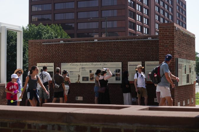 Visitors to the President's House, where new panels have been installed. Historians and advocates have criticized the panels for minimizing Washington's role as an enslaver.