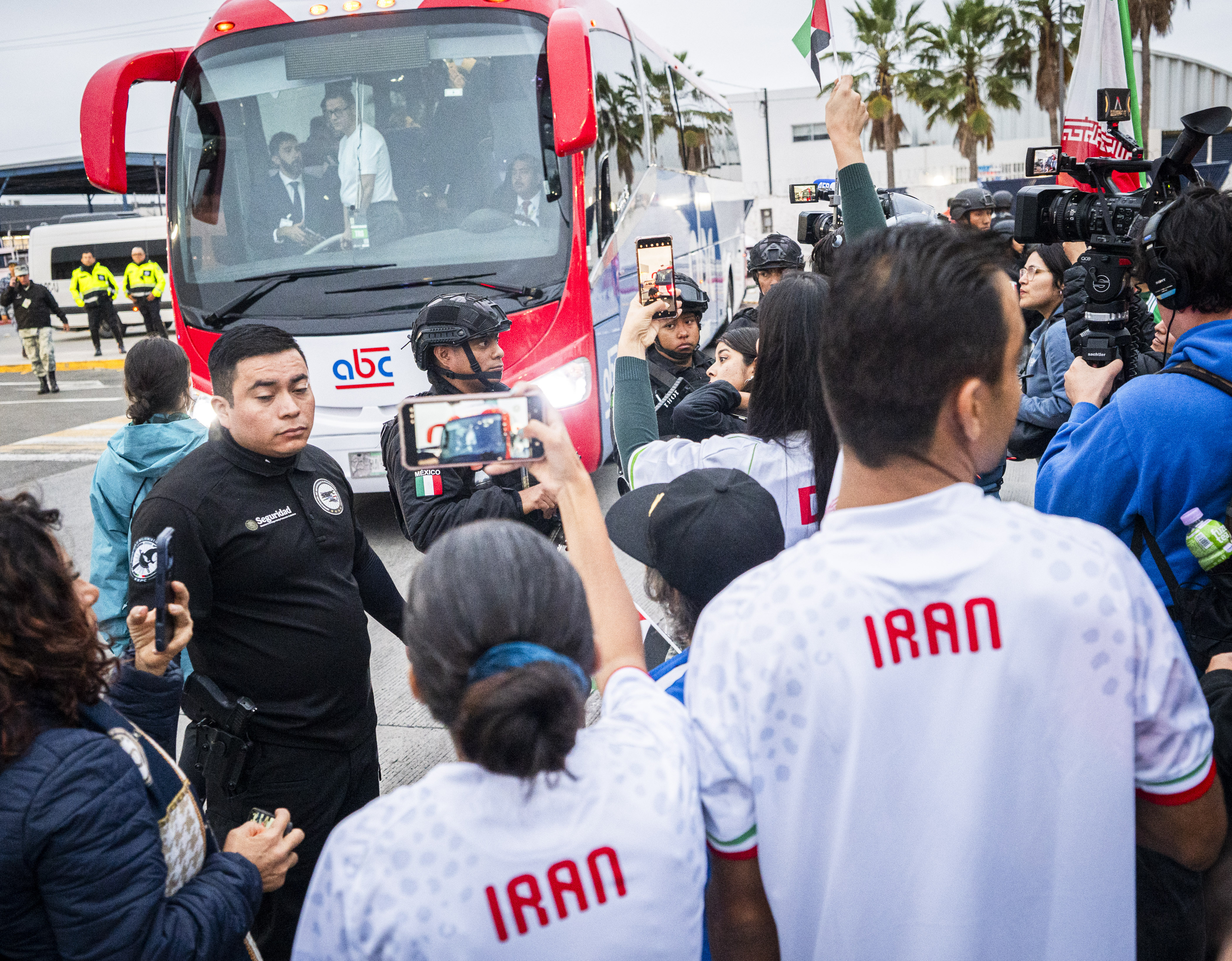 Maryam Galavi (left) and Sedagh Galavi film and cheer at the arrival of the Iran men’s soccer team in Tijuana, Mexico, on Sunday.