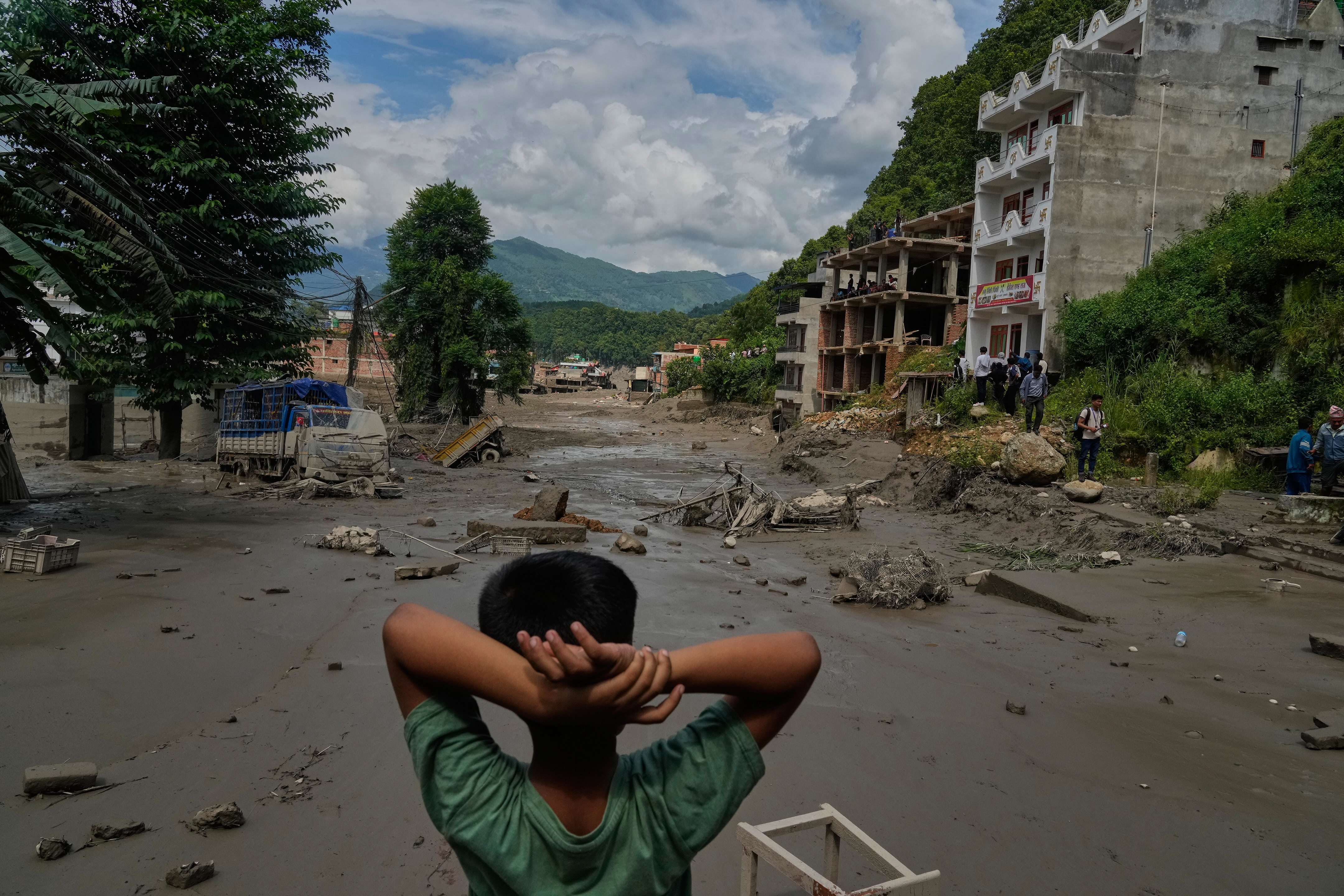 At least 160 killed and hundreds missing after flash floods in Nepal and China