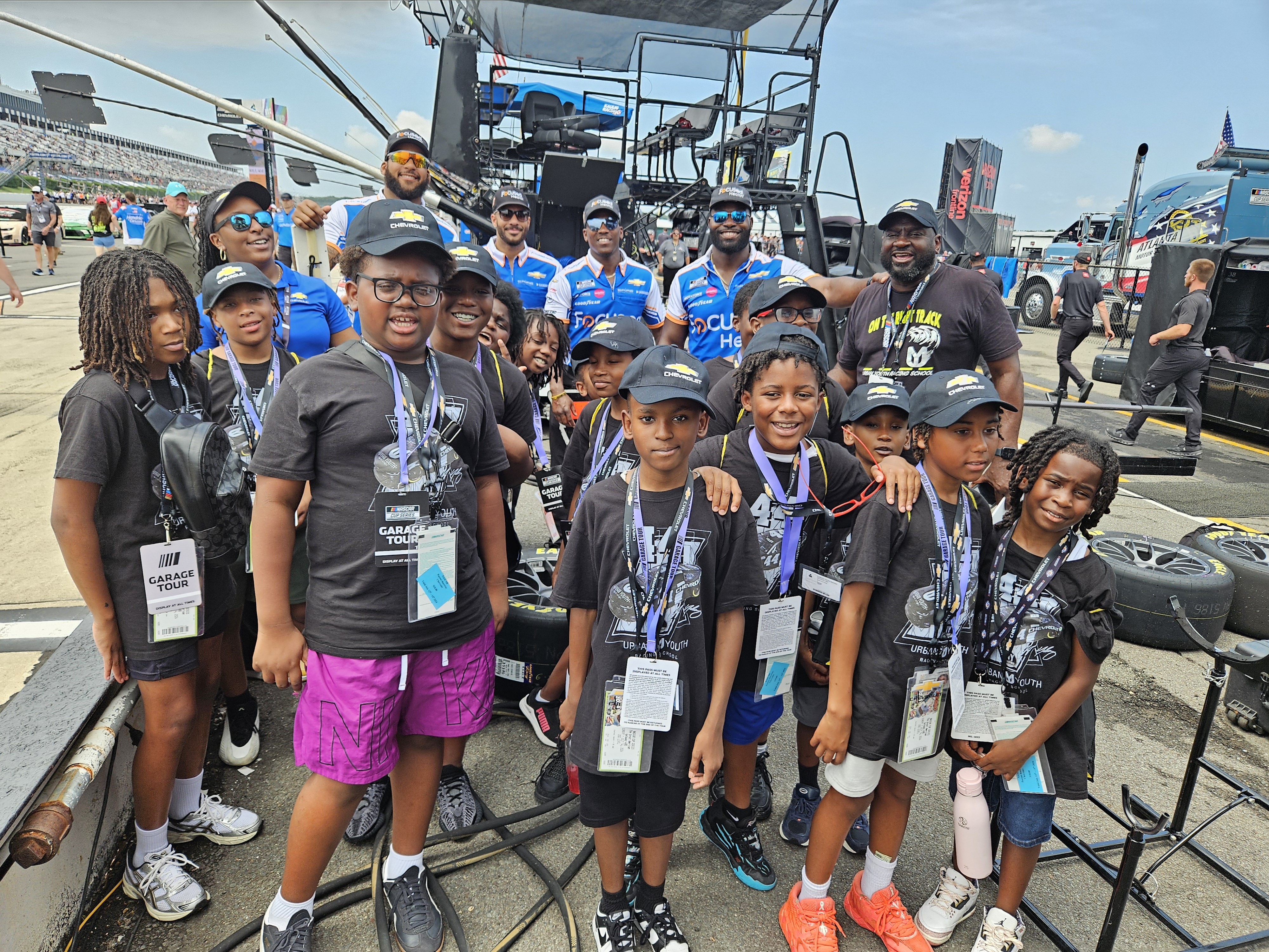 Urban Youth Racing School students participate in an outing at a track.