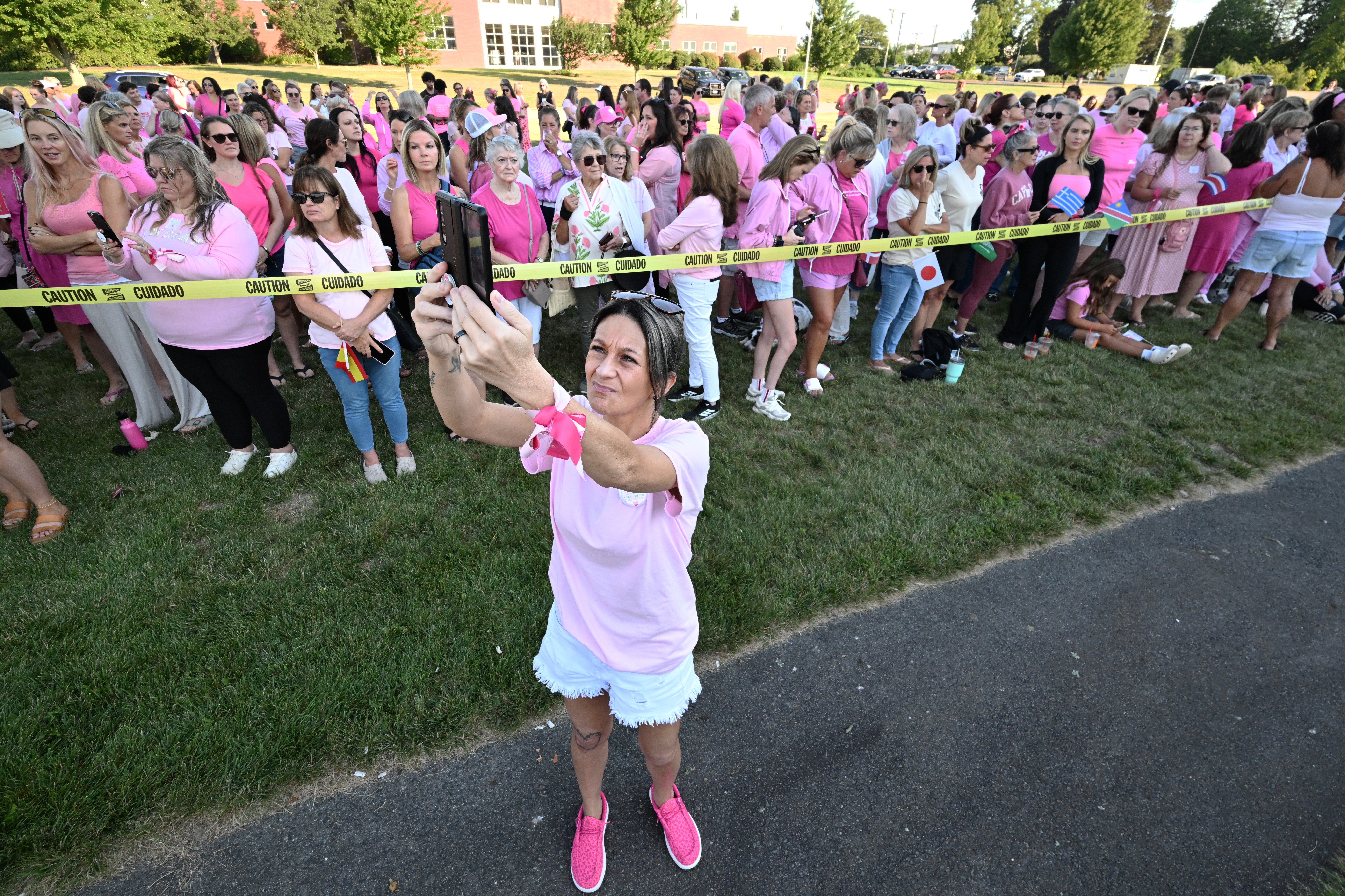 Women in pink rally in support of Lindsay Clancy, who is on trial for killing 3 children