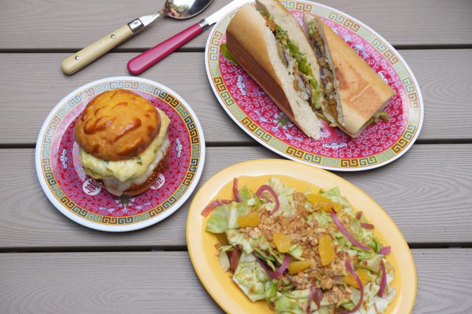Clockwise from top: The eggplant empanizado sandwich, ensalada fresca, and the Chino breakfast sandwich at Chibanos, 1127 Pine St.