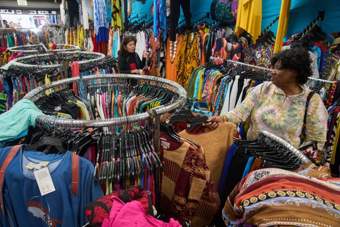 Business owner Asha Sham (left) assists a wholesale client, fashion designer Diana Axtell, with purchasing African-imported clothing wholesale in Los Angeles in 2025. Trump administration policies are causing unease among U.S. businesses that trade with African nations, writes Alexanderia Haidara.