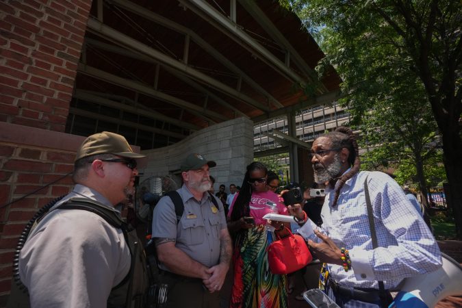 Lawyer Michael Coard advocates for his First Amendment rights to gather and speak freely at the President's House Site, where Coard and others planned a news conference Wednesday to address the installation of new panels.