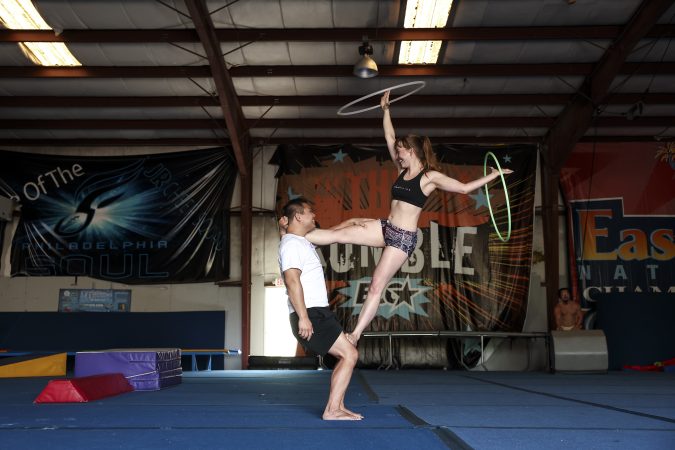 Rob Li (left) and Acacia Noel work on a skill with hoops during a Philly Acro skill share on July 5 at Power Athletics in Atco, NJ.