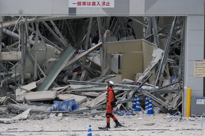 Rescuers search for survivors after a 7.1 quake kills 18 in southwestern Japan