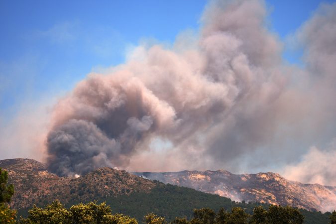 More than 200,000 people flee raging wildfires in France and Spain, some escaping by boat
