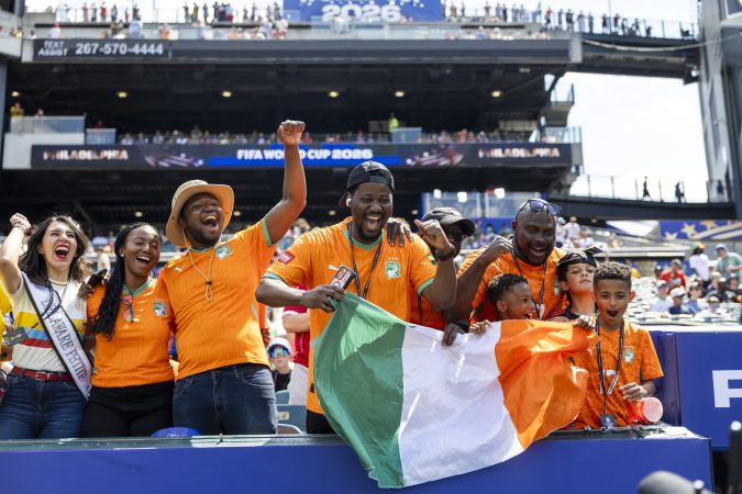 Fans of Ivory Coast hold up the country's flag before their match against Curaçao in Philly on Thursday.