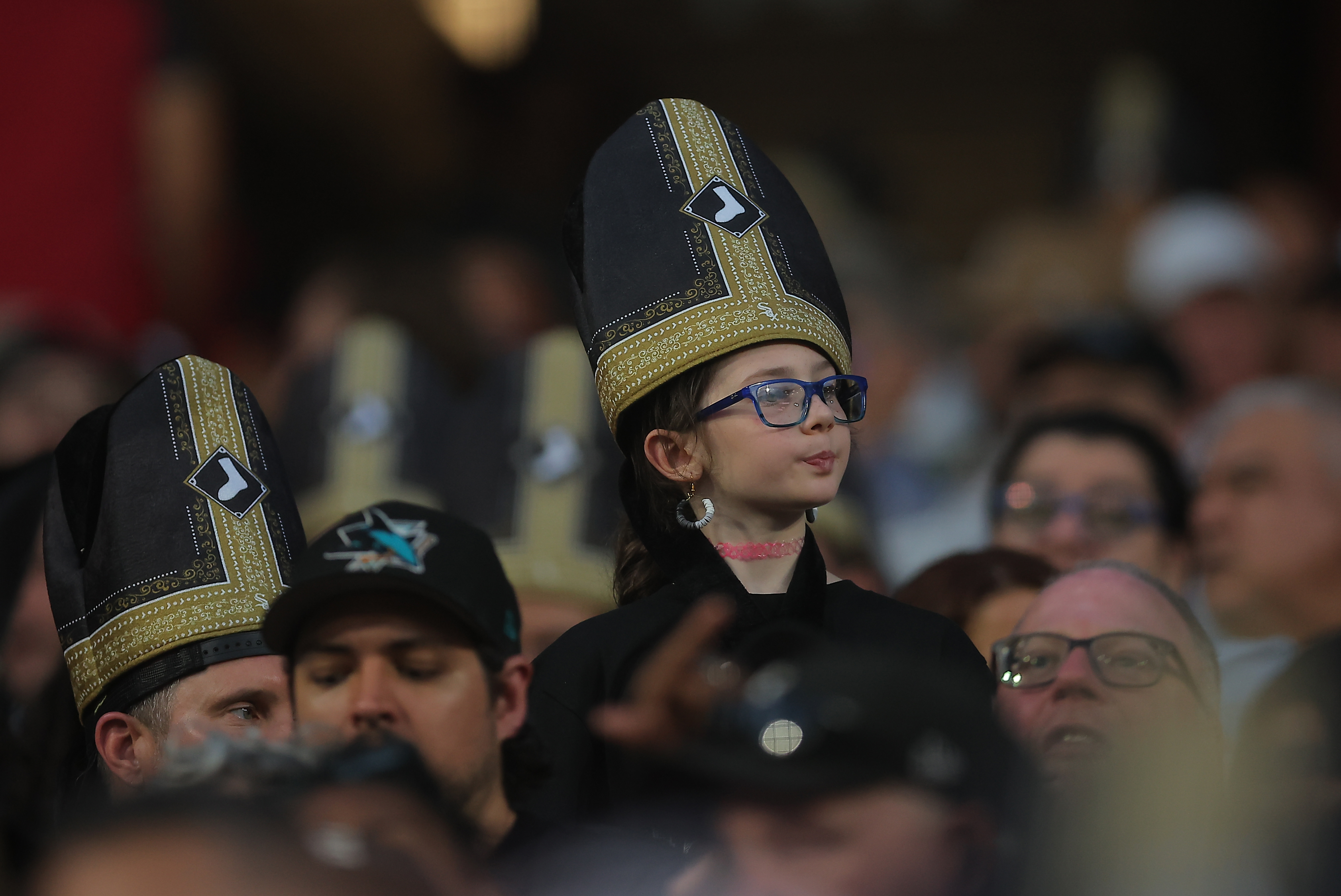 A fan wears a promotional pope hat during a baseball game between the Cincinnati Reds and Chicago White Sox, Tuesday, Aug. 11, 2026, in Chicago.