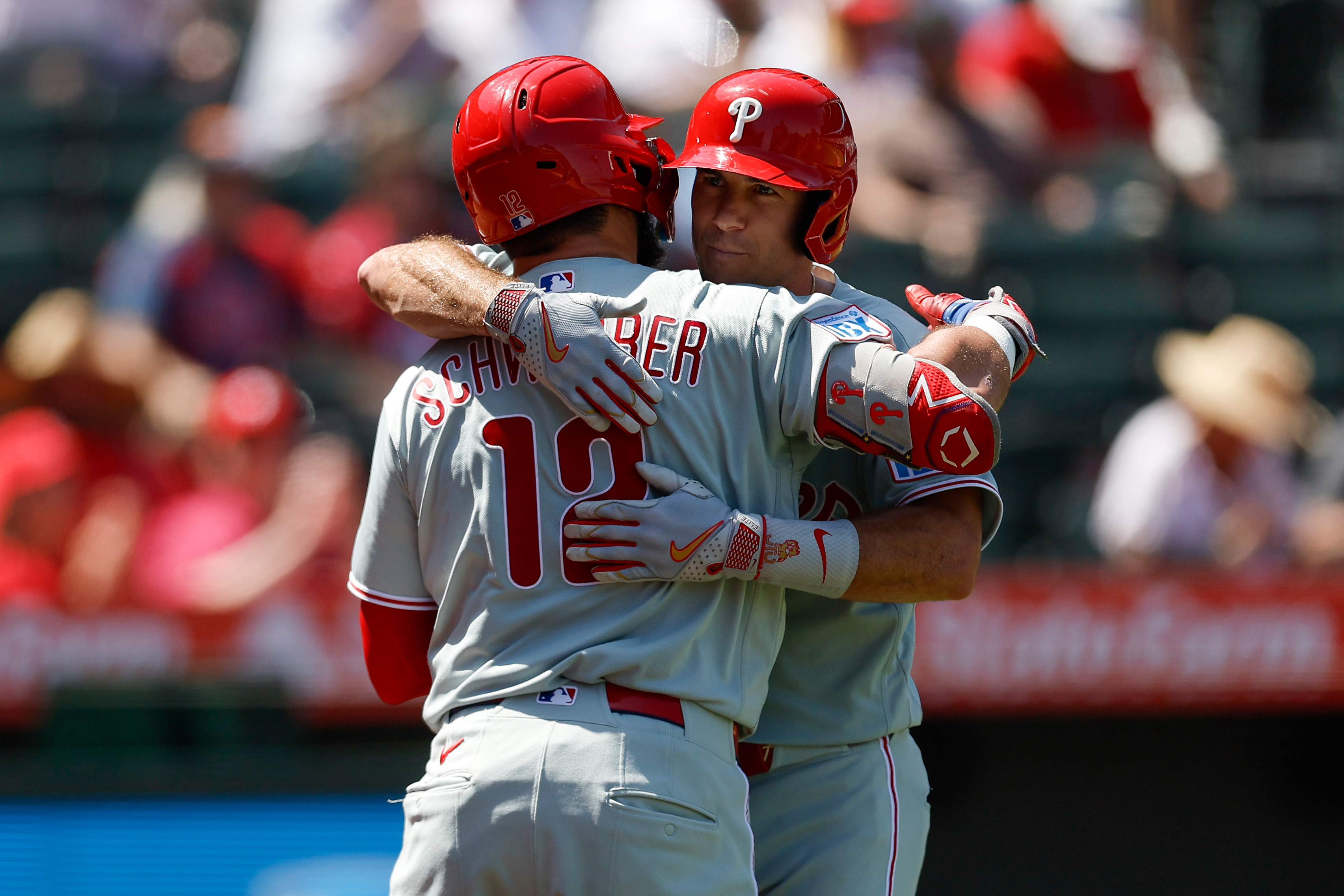 Philadelphia Phillies' J.T. Realmuto, right, is greeted by Kyle Schwarber, left, after hitting a solo home run during the third inning of a baseball game against the Los Angeles Angels, Sunday, Aug. 30, 2026, in Anaheim, Calif. (AP Photo/Caroline Brehman)