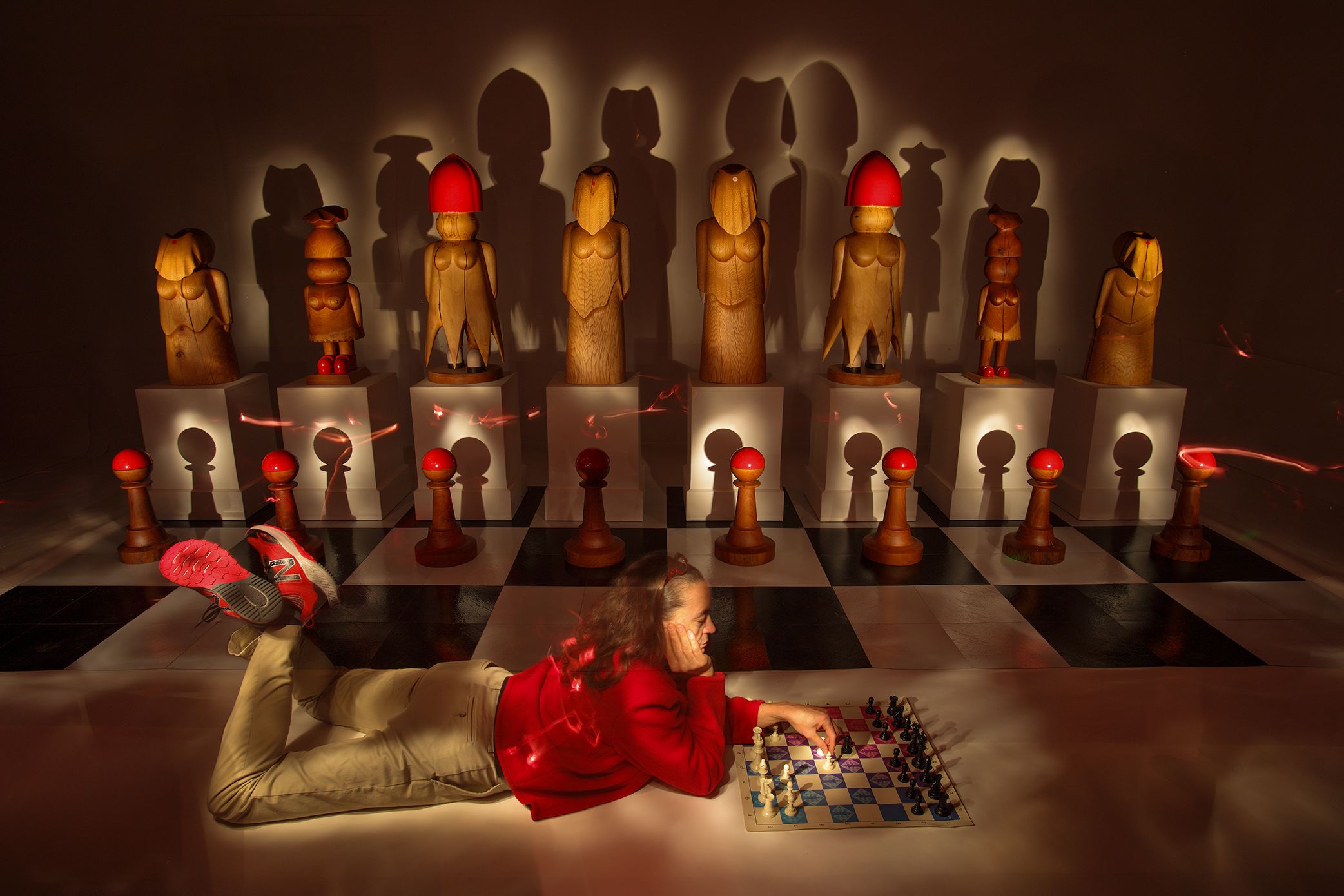 A large chess board with life-size pieces is posing questions about gender roles and hierarchy
