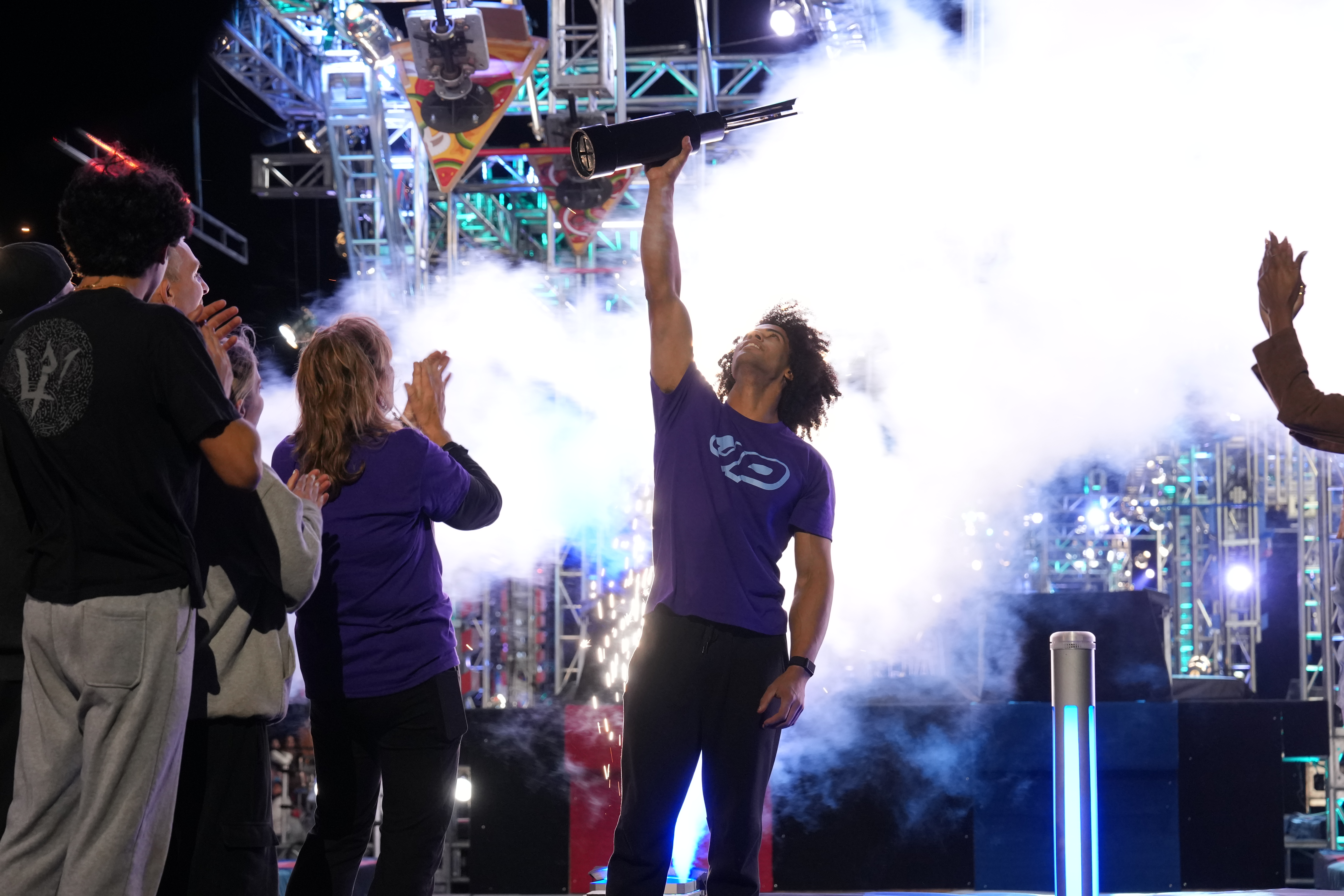 Josiah Pippel celebrates with the winner's trophy after the final of "American Ninja Warrior."
