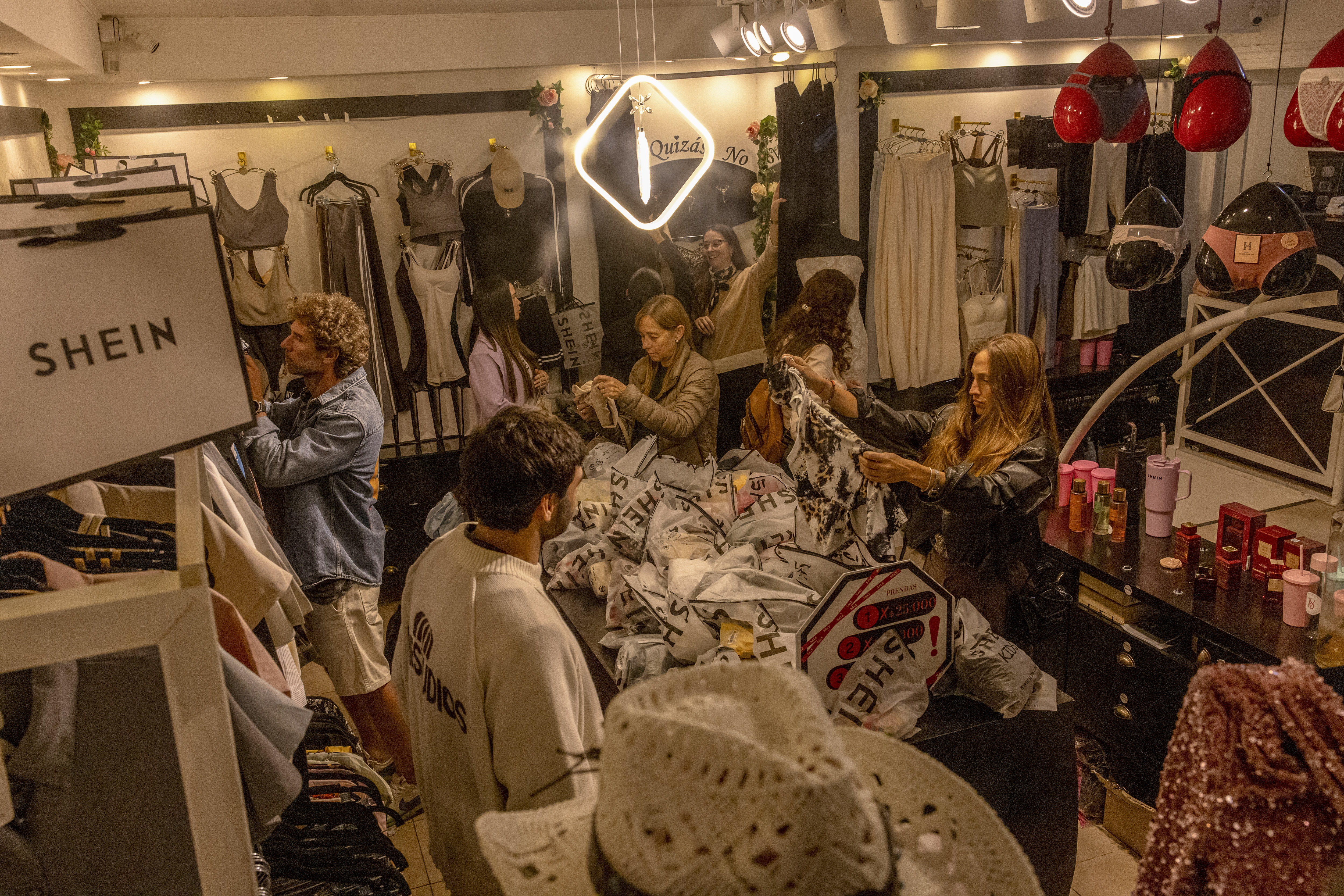Customers shop during the opening of a Shein resale store in Buenos Aires, Argentina, in November 2025. Once the world’s largest fashion retailer, Shein built its fast-fashion empire by using algorithms to track trends and compress production cycles from months to days.