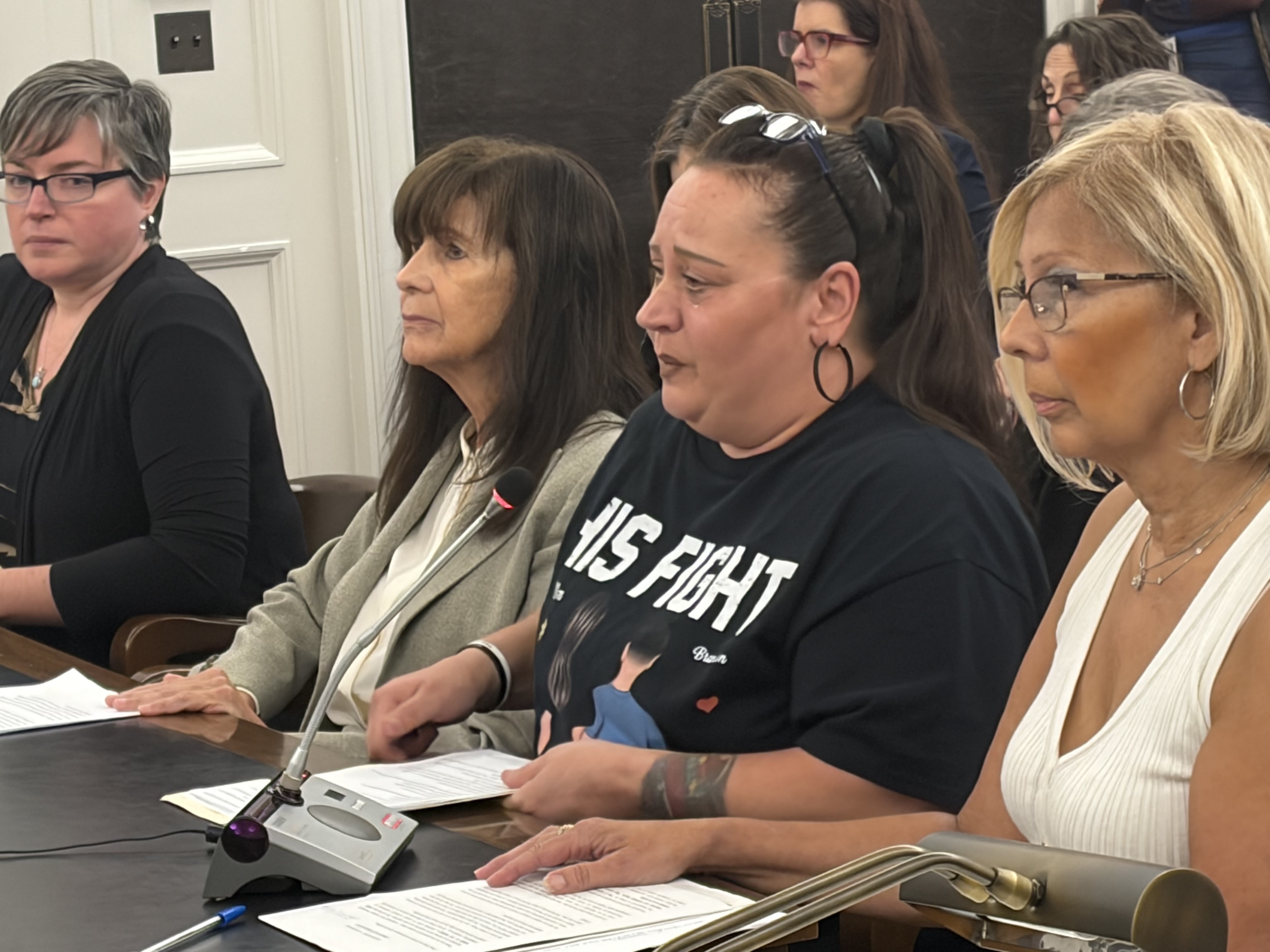 Priscilla Quesada (second from right) of Egg Harbor Township, whose son resides in a group home, participates in a New Jersey legislative hearing in Trenton on a bill that would require installing cameras to improve safety at the facilities for people with developmental disabilities, on Monday, Sept. 14, 2026.