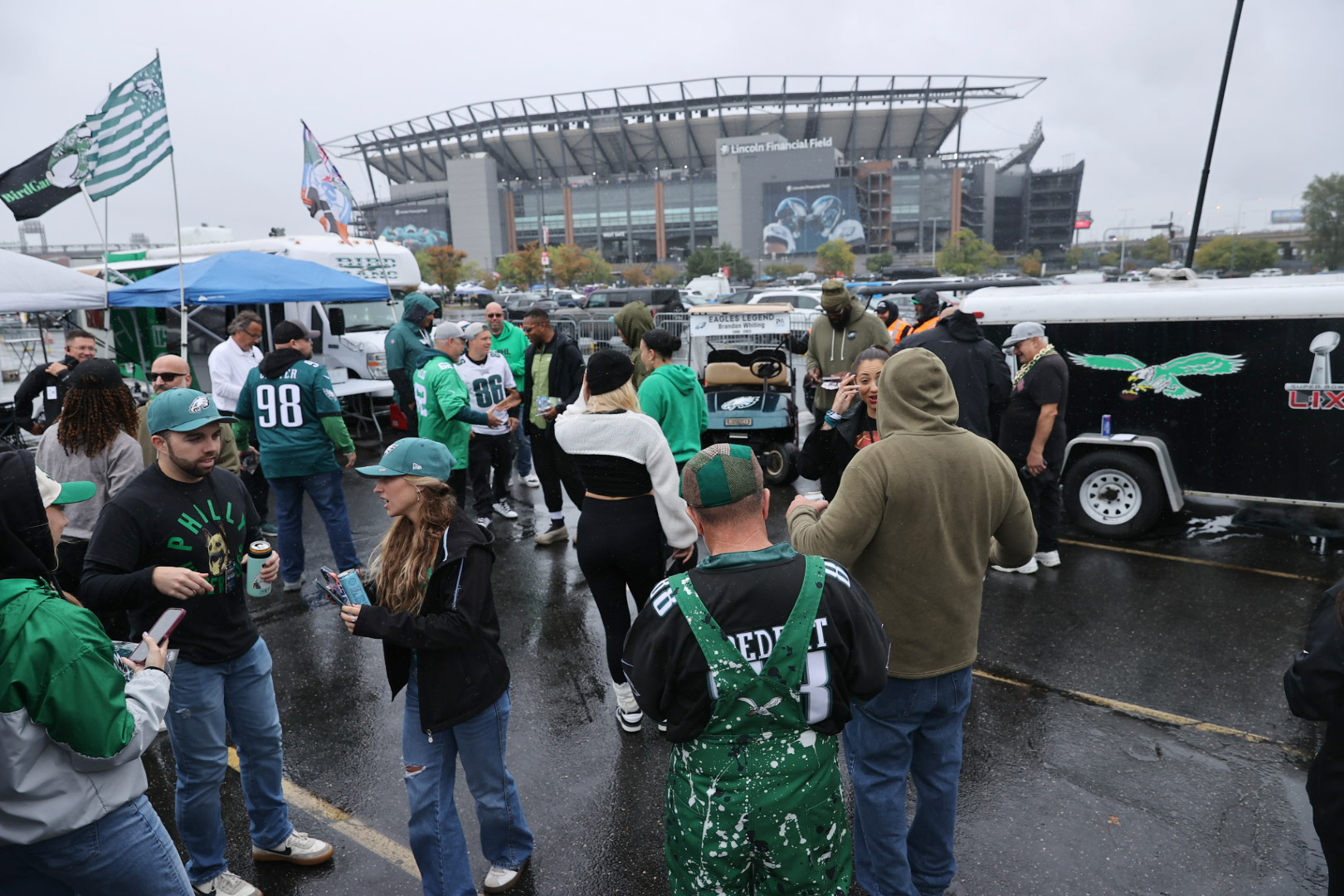 People gather at Carmen Conti’s tailgate party in Lot D before the Eagles play the Rams at Lincoln Financial Field on Sunday.