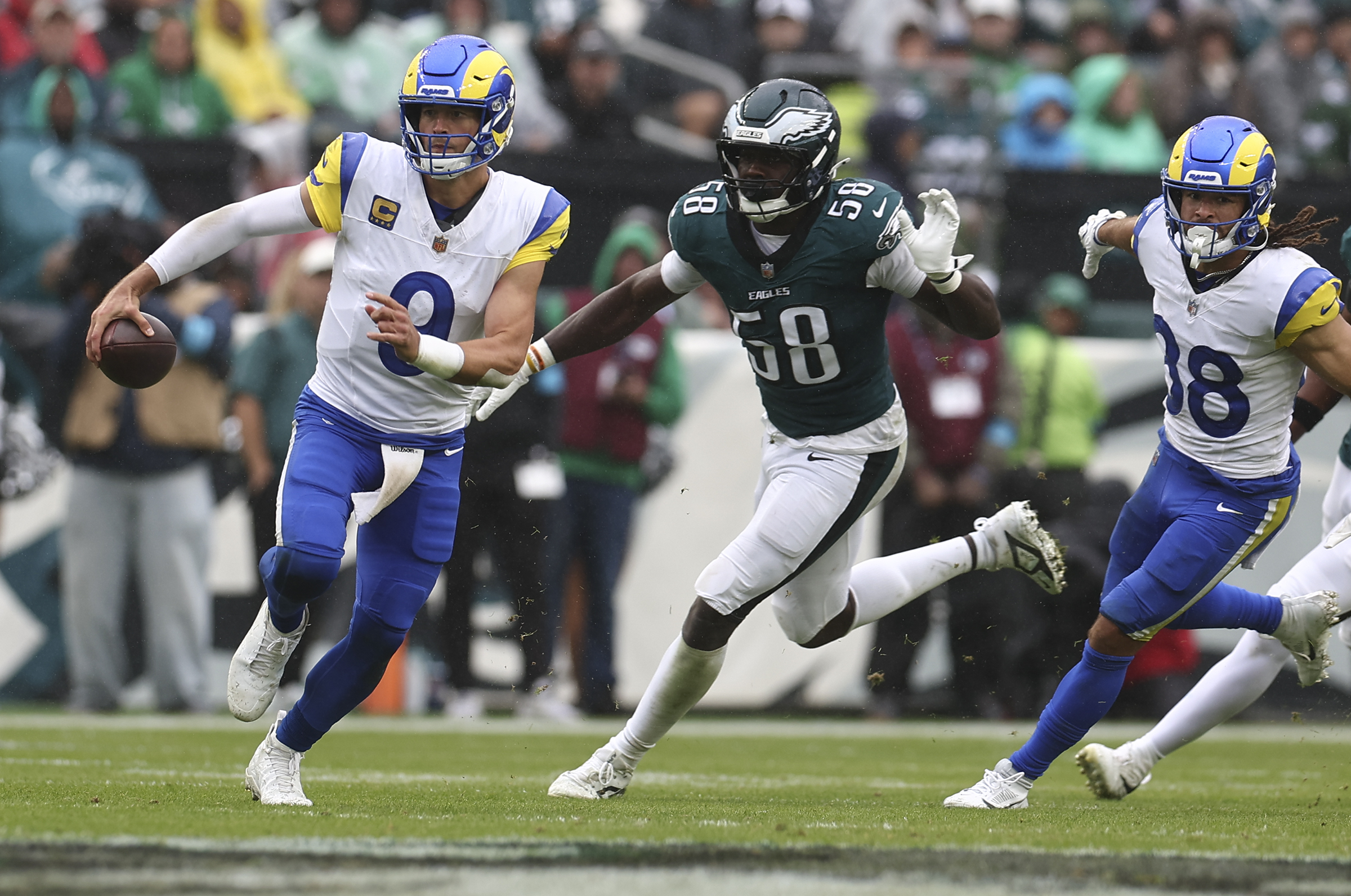 Los Angeles Rams quarterback Matthew Stafford runs past Eagles linebacker Jalyx Hunt on Sunday.