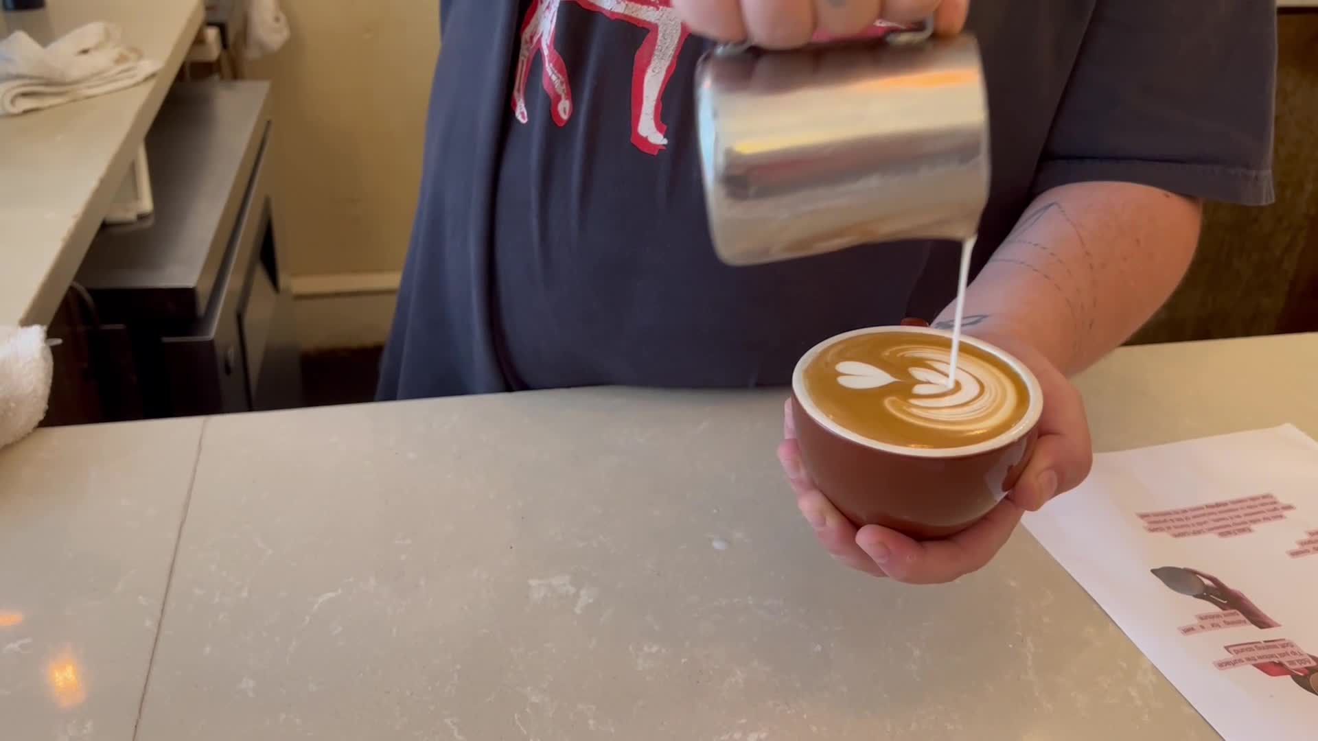 Ox Coffee consultant demonstrates pouring milk in a Latte Art 101 class